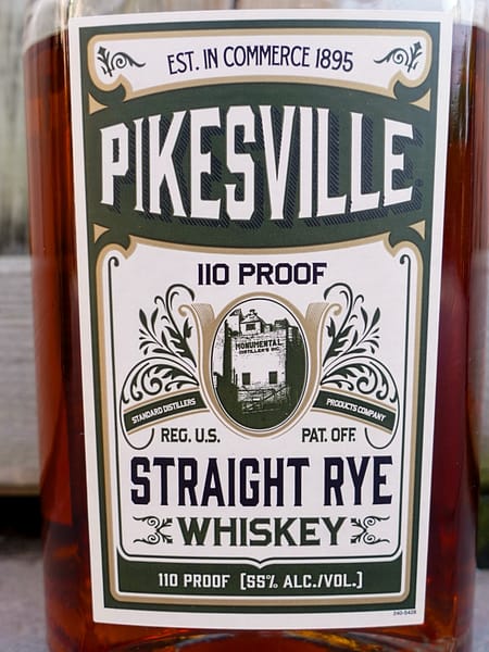 Pikesville Straight Rye Whiskey Bottle Label showing the 110 proof and an image of Monumental Distillery which produced the whisky until 1972