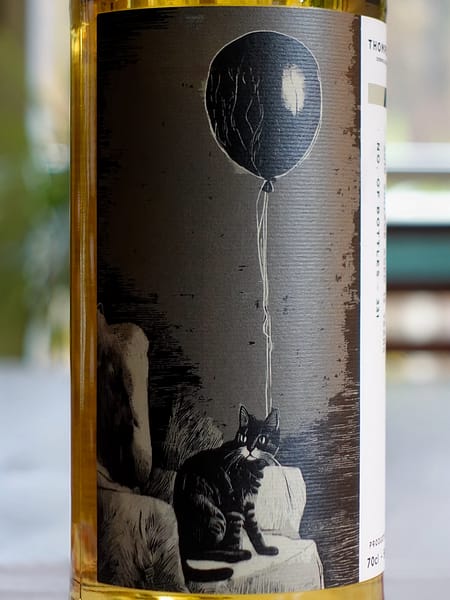 Front label detail of the Thompson Bros. 2010 Linkwood 13-year-old bottle showing the artwork depicting a greyscale picture of a cat with an inflated balloon