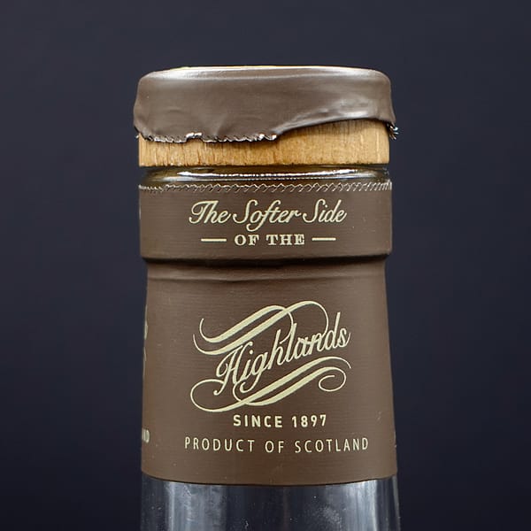 Tomatin Legacy cap band detail with the motto "The Softer Side of the Highlands"