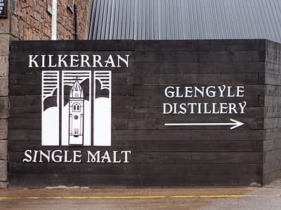 Picture of the entrance to Glengyle Distillery, showing the name of the distillery and a large logo of the Kilkerran Sngle Malt produced here