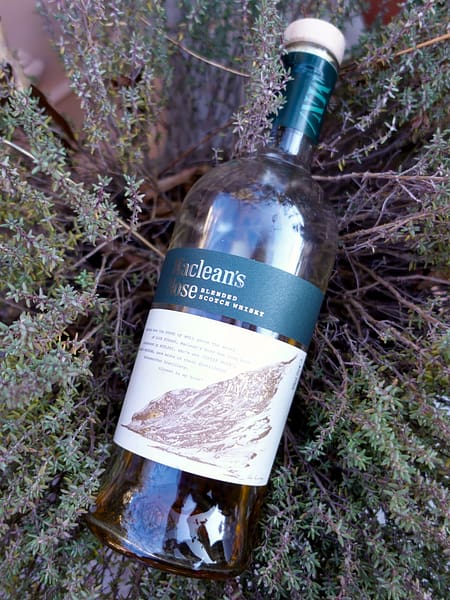 Picture of Adelphi's Maclean's Nose bottle laying on a background of thyme branches