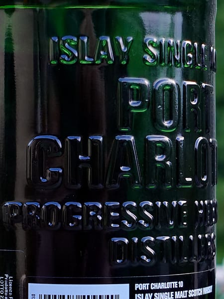 Port Charlotte 10 bottle detail showing the embossed distillery name on the back of the bottle
