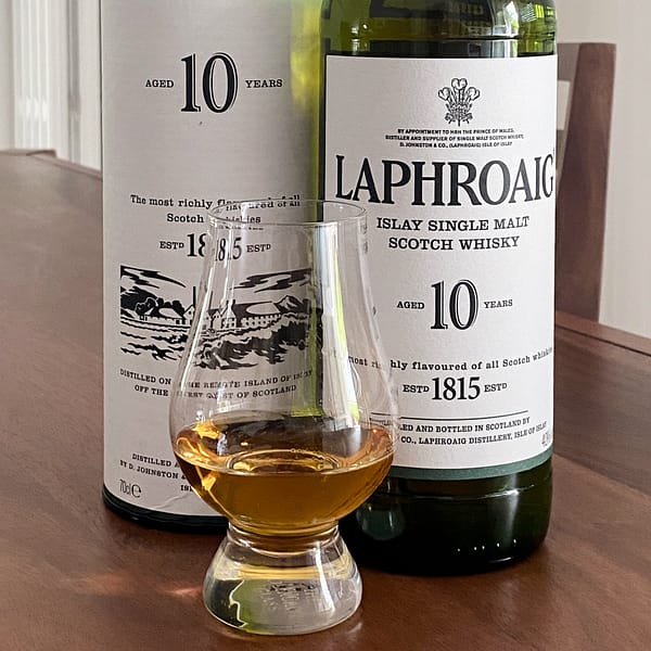 Laphroaig 10 year old bottle with tube box and Glencairn whisky glass