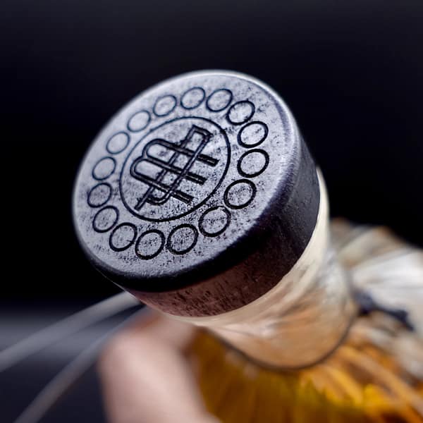 White Peak Wire Works whisky cap detail, showing the company's logo representing a W and a P intersecting each other