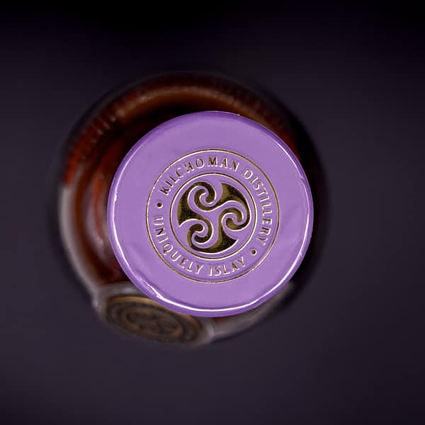 Kilchoman Sanaig bottle cap seal showing the distillery's triskelion logo