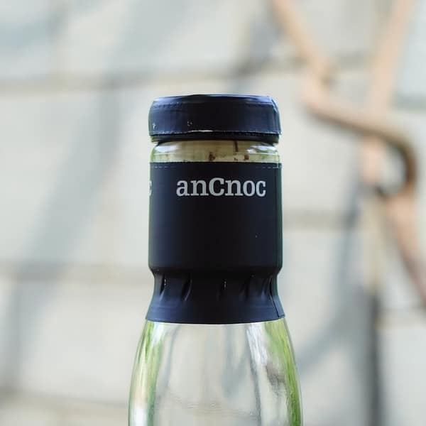 anCnoc 18 year old neck detail showing the cap seal carrying the distillery name in white on black