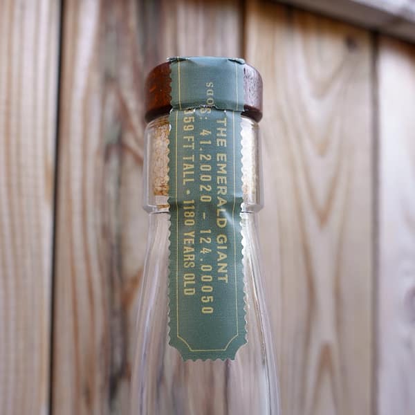 Redwood Empire Emerald Giant cap seal, showing information on the Emerald Giant tree located in the Redwood forest