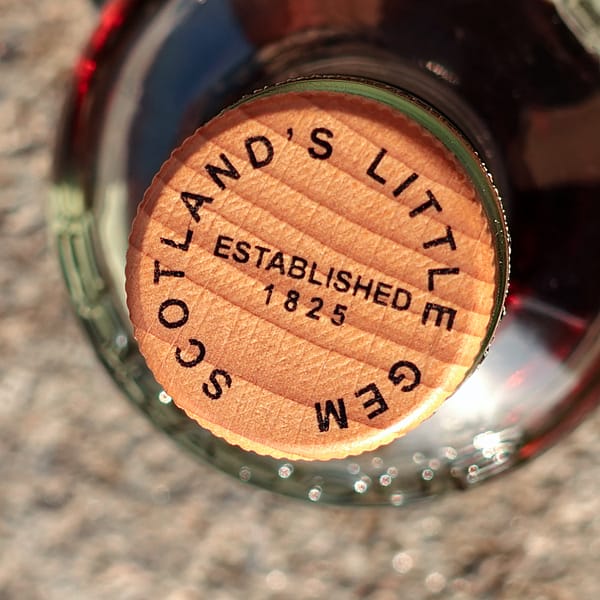 Edradour Caledonia 12-year-old stopper detail with the distillery motto "Scotland's Little Gem"