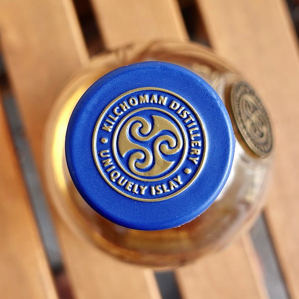 Kilchoman 100% Islay 13th Edition cap seal showing the distillery's triskelion logo