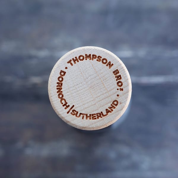 TB/BSW bottle stopper caarying the text " Thompson Bro.s - Dornoch, Sutherland"
