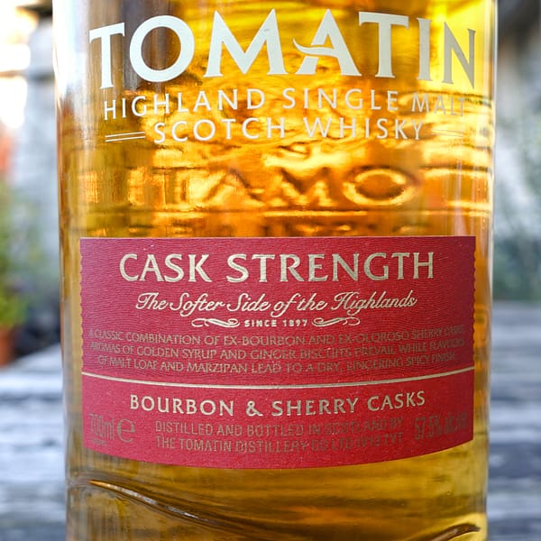 Front label detail of the Tomatin Cask Strength single malt bottle, highlighting the ageing in Bourbon and Sherry casks
