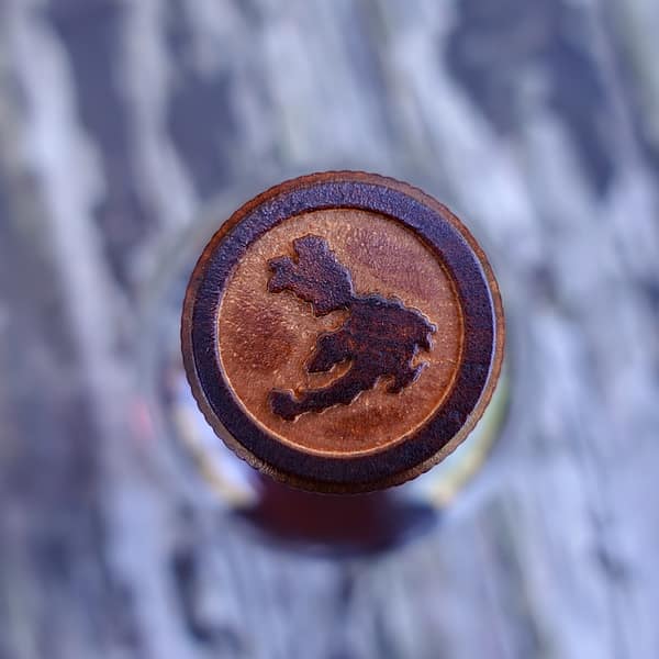 Ledaig Sinclair Series Rioja Cask stopper showing an outline of the isle of mull engraved in the wood