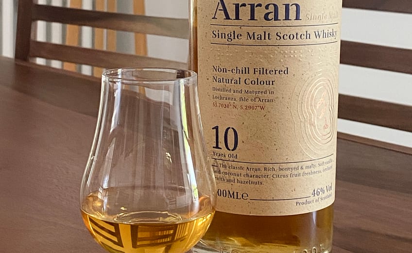 Picture of an Arran 10 year old bottle with a Glencairn glass containing a dram of the whisky