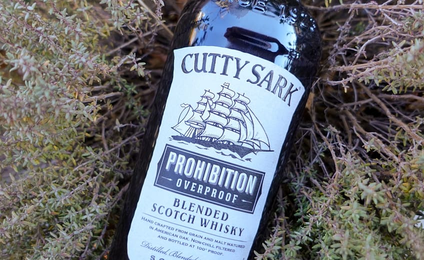 Image of the Cutty Sark Prohibition blended scotch bottle resting on vegetation