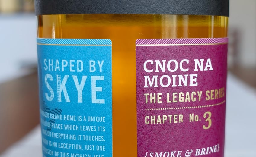 Torabhaing Cnoc Na Moine label made up of three paper panel leaving a negative space capital T in the middle