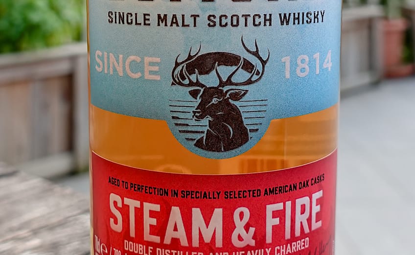 Loch Lomond Steam & Fire Label, split between the red bottom stip representing fire and the top light blue label, representing steam