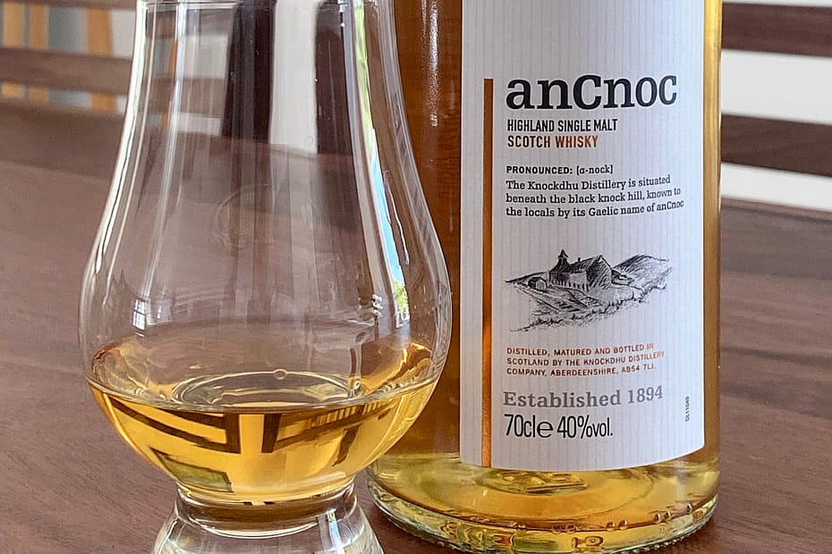 picture of an anCnoc 12-year-old bottle with Glencairn glass containing some of the same whisky