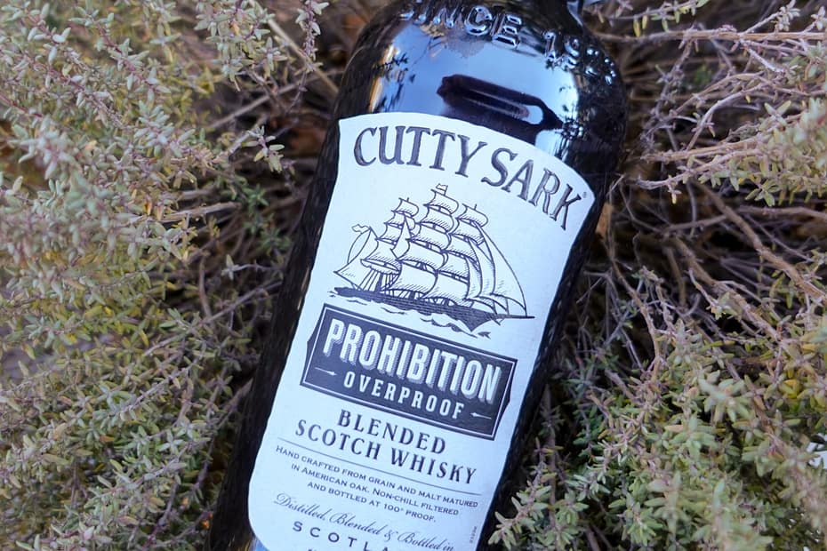 Image of the Cutty Sark Prohibition blended scotch bottle resting on vegetation