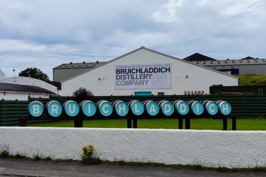 Bruichladdich's Distillery welcome sign, made out of barrels, each carrying a different letter in the name in white on turquoise background