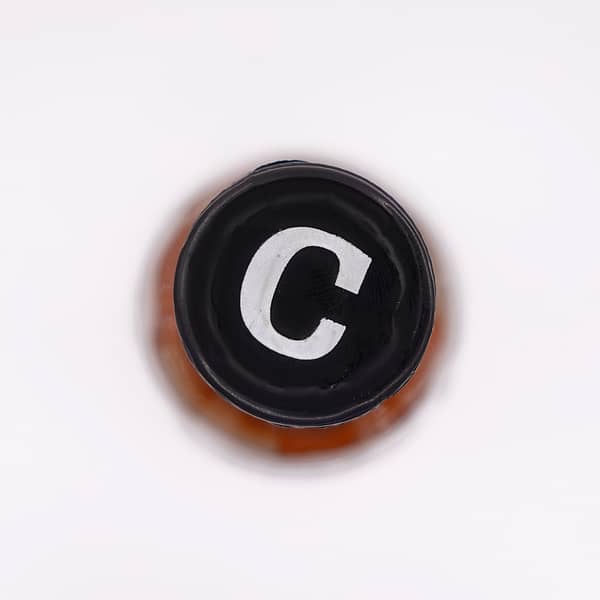 anCnoc 12-year-old cap detail showing a large white capital C on black background