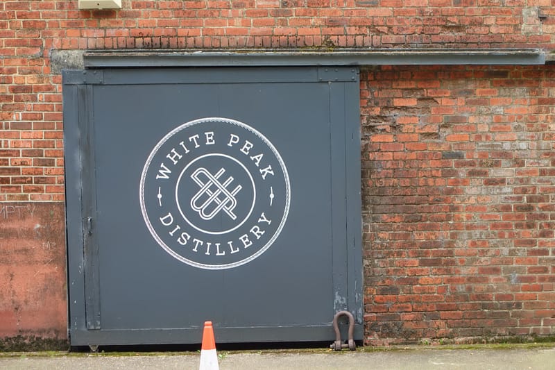 White Peak distillery, gate with painted logo